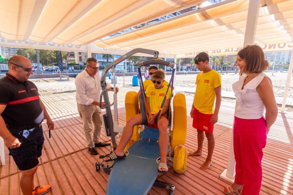Benidorm estrena una grúa para facilitar aún más el baño de personas con movilidad reducida en la playa