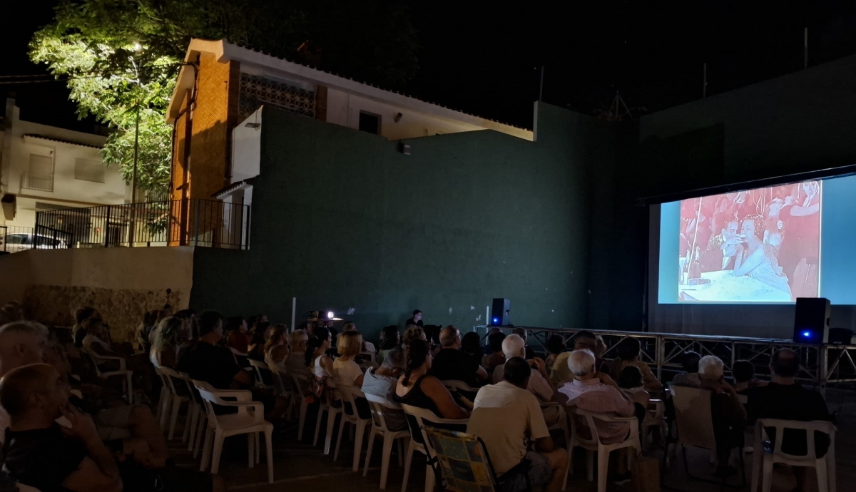 Proyección de Moros y cristianos en Benialí con el pianista al fondo. 
