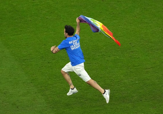 Un aficionado invade el campo con una bandera arcoíris durante el Portugal-Uruguay