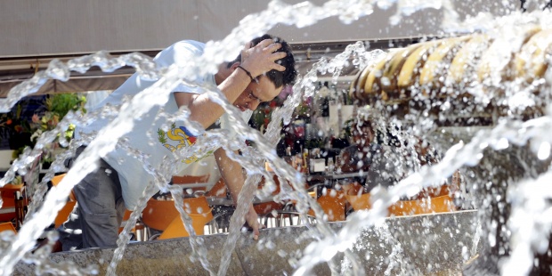 Un hombre se refresca en una fuente. Foto: EFE - 